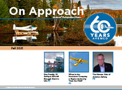 Thumbnail image of newsletter cover. Main photo is of a float plane on the water in Alaska. Beautiful fall foliage in the background. Blue heron standing in  the water at the foreground of the photo.